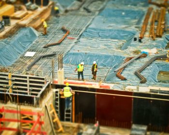 High-angle view of construction workers on a building site, engaging in construction work.